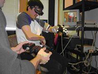 An Augmented Reality Training Environment for Post-Stroke Finger Extension Rehabilitation